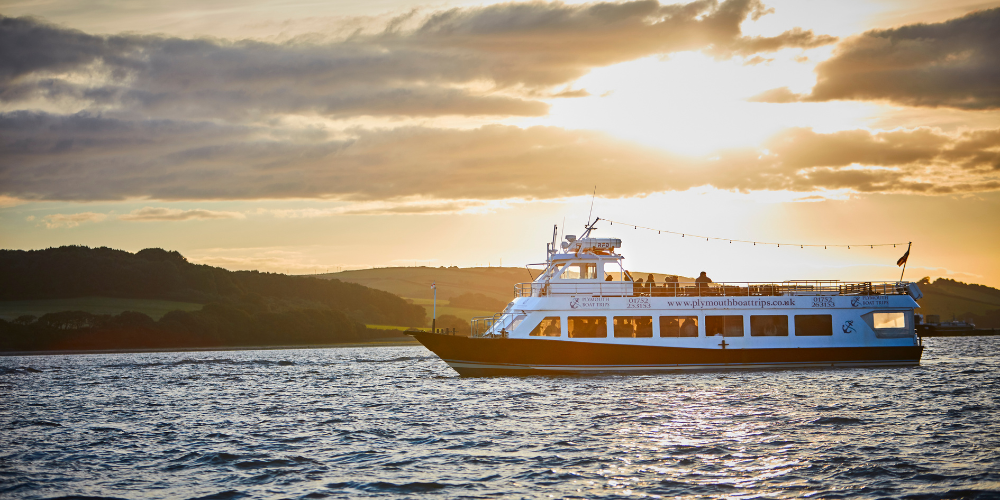Passenger boat cruising on Plymouth waters at sunset